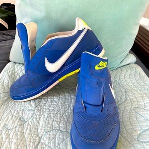 Blue pair of Nike sneakers, neon yellow accents, white swoosh